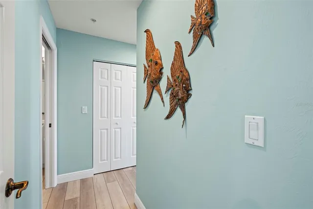 a view of a hallway with dining area and glass door
