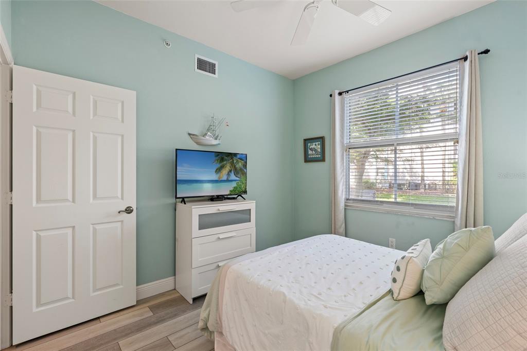 2060 Matecumbe Key Road, Unit 2106 Punta Gorda, FL 33955 - Photo 26 of 56 a bedroom with a bed and a flat screen tv