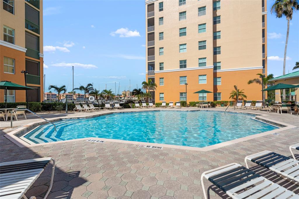 2060 Matecumbe Key Road, Unit 2106 Punta Gorda, FL 33955 - Photo 39 of 56 a view of a swimming pool with a bench and trees