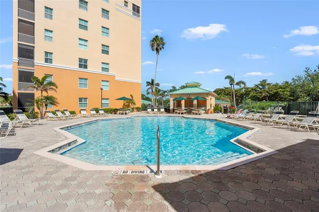 a view of water with boats and trees in the background