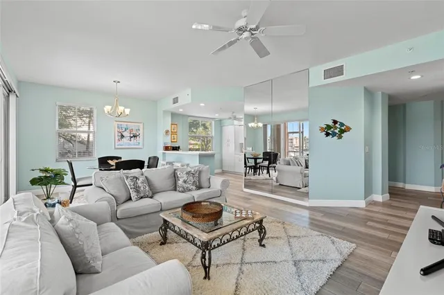 a living room with furniture and a chandelier