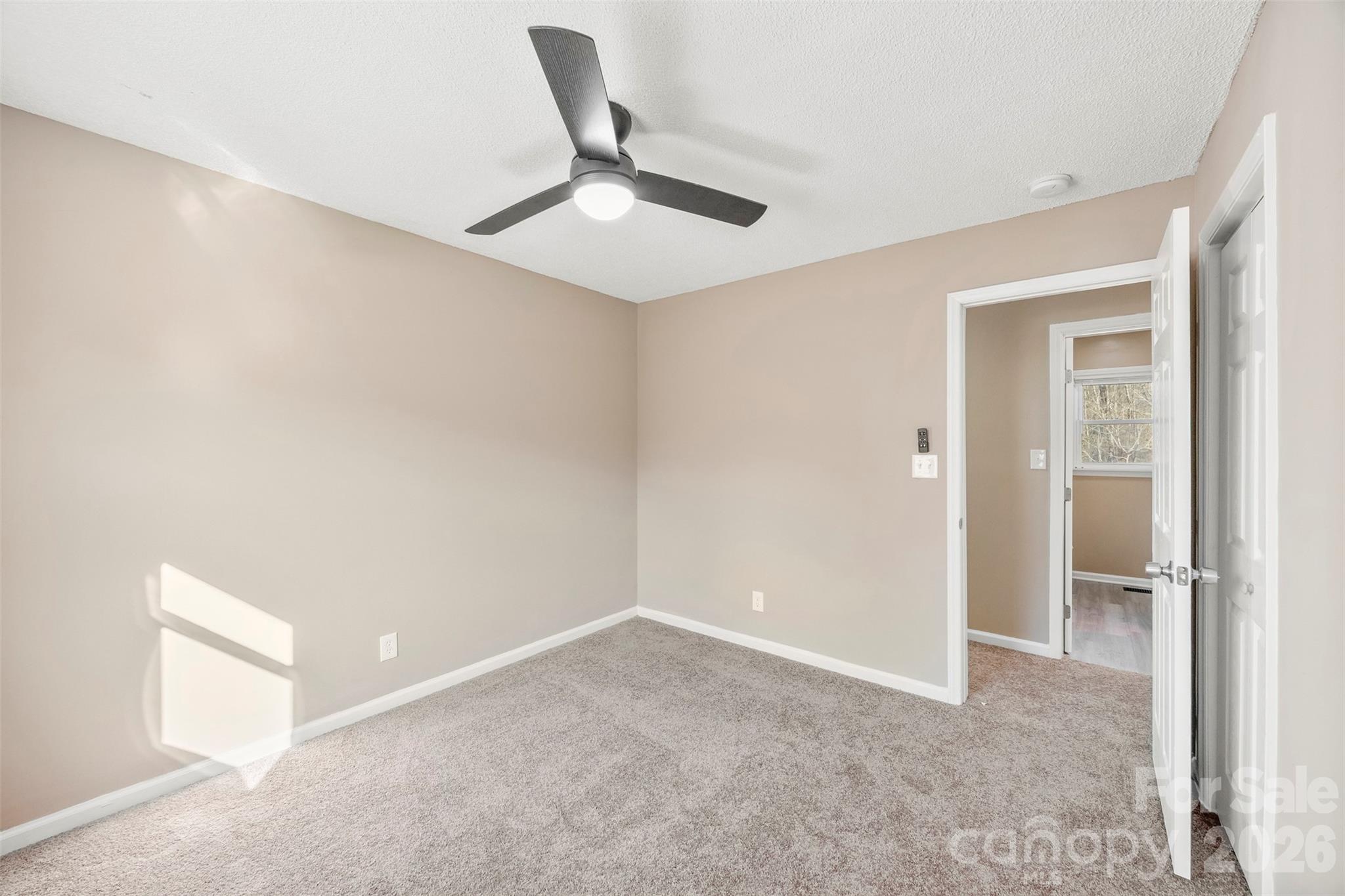 161 Potato House Road Lawndale, NC 28090 - Photo 18 of 33 an empty room with a ceiling fan and carpet