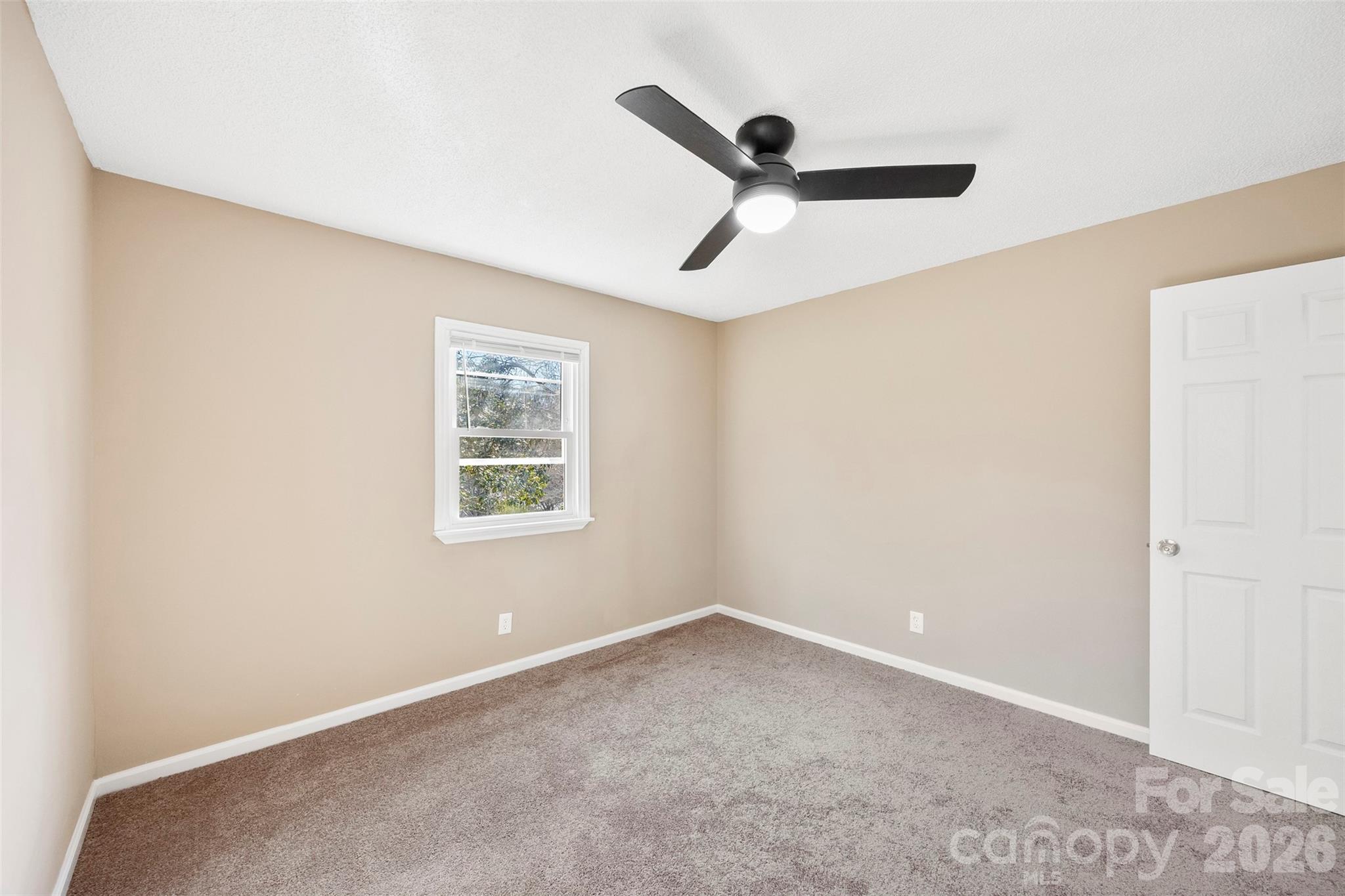 161 Potato House Road Lawndale, NC 28090 - Photo 20 of 33 an empty room with a window and a ceiling fan