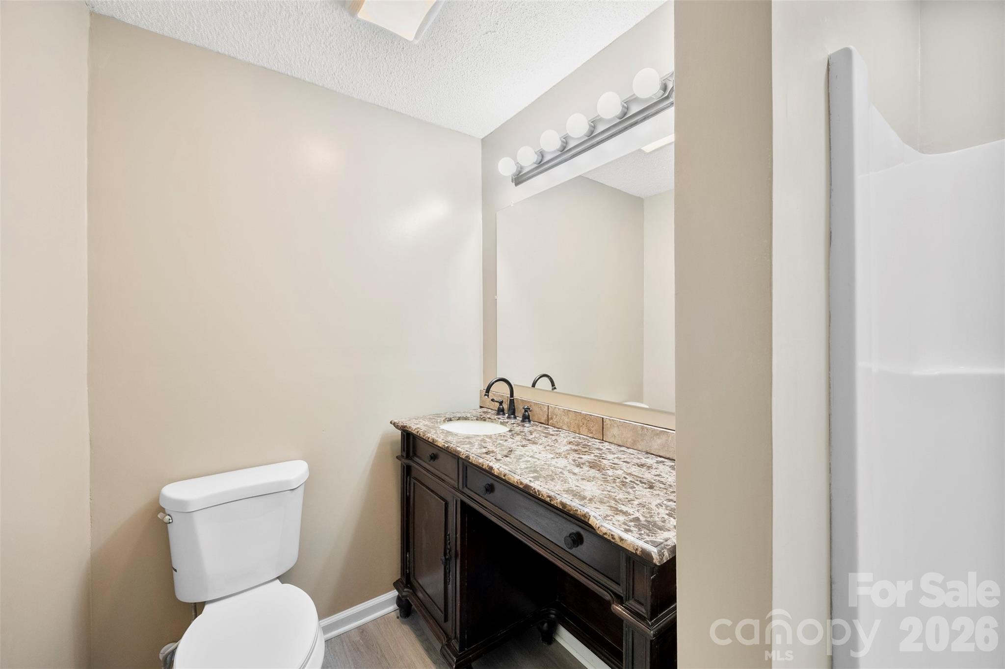 161 Potato House Road Lawndale, NC 28090 - Photo 25 of 33 a bathroom with a granite countertop toilet sink and mirror