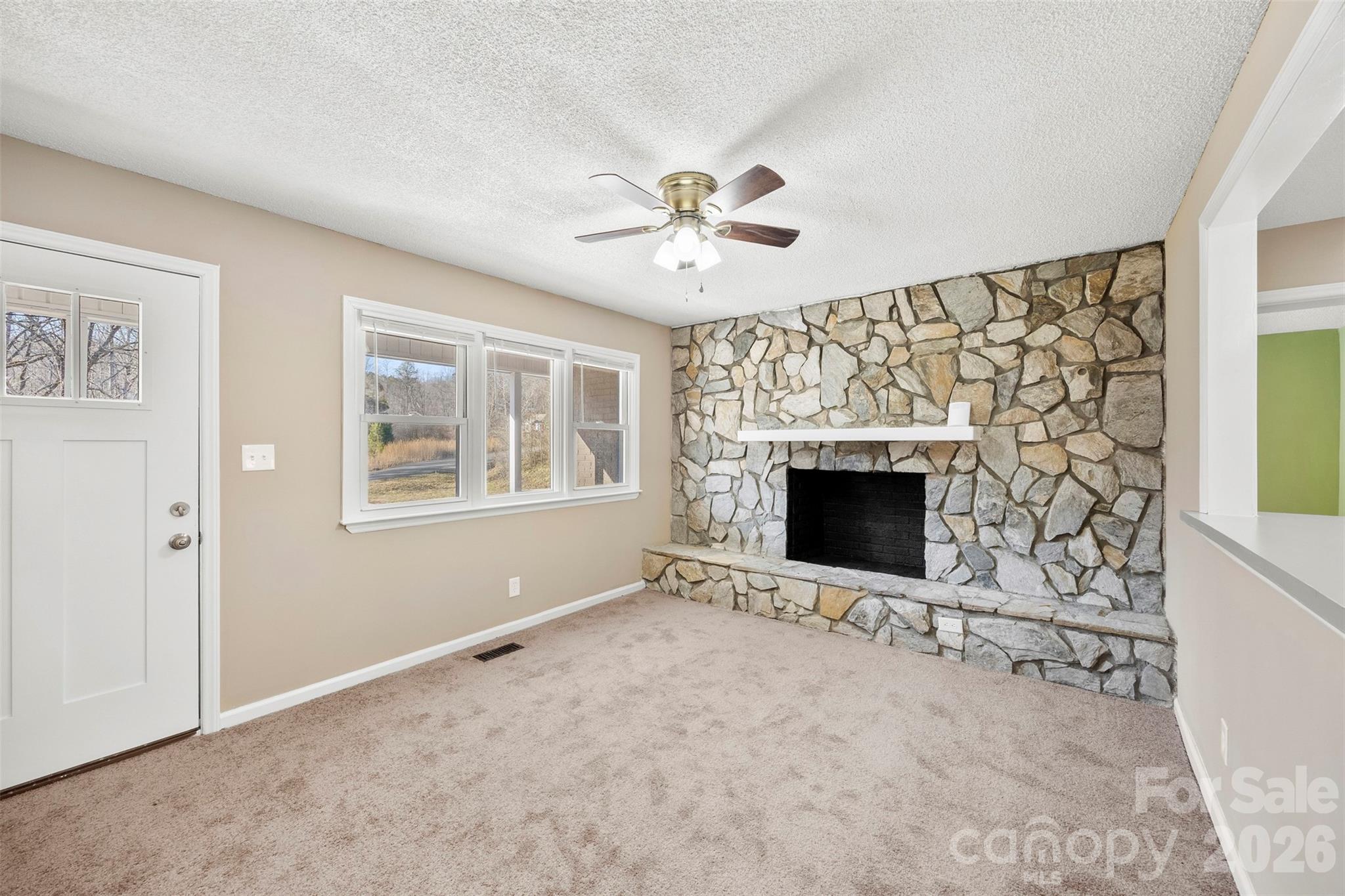 161 Potato House Road Lawndale, NC 28090 - Photo 3 of 33 a view of an empty room with a fireplace and a window
