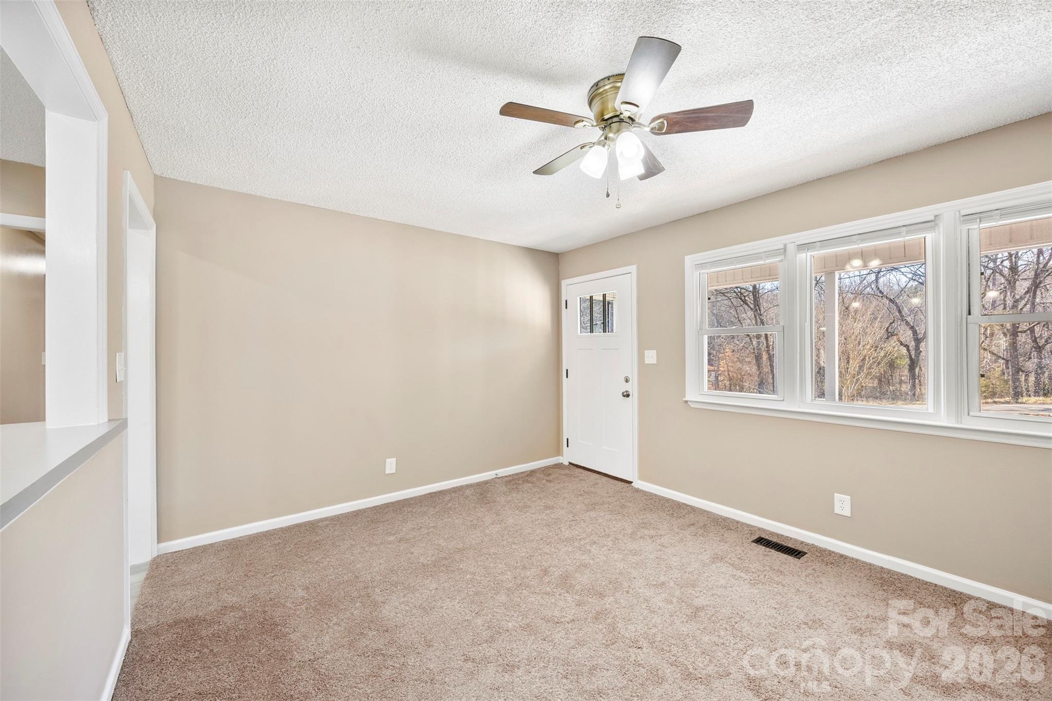 161 Potato House Road Lawndale, NC 28090 - Photo 5 of 33 an empty room with windows and fan