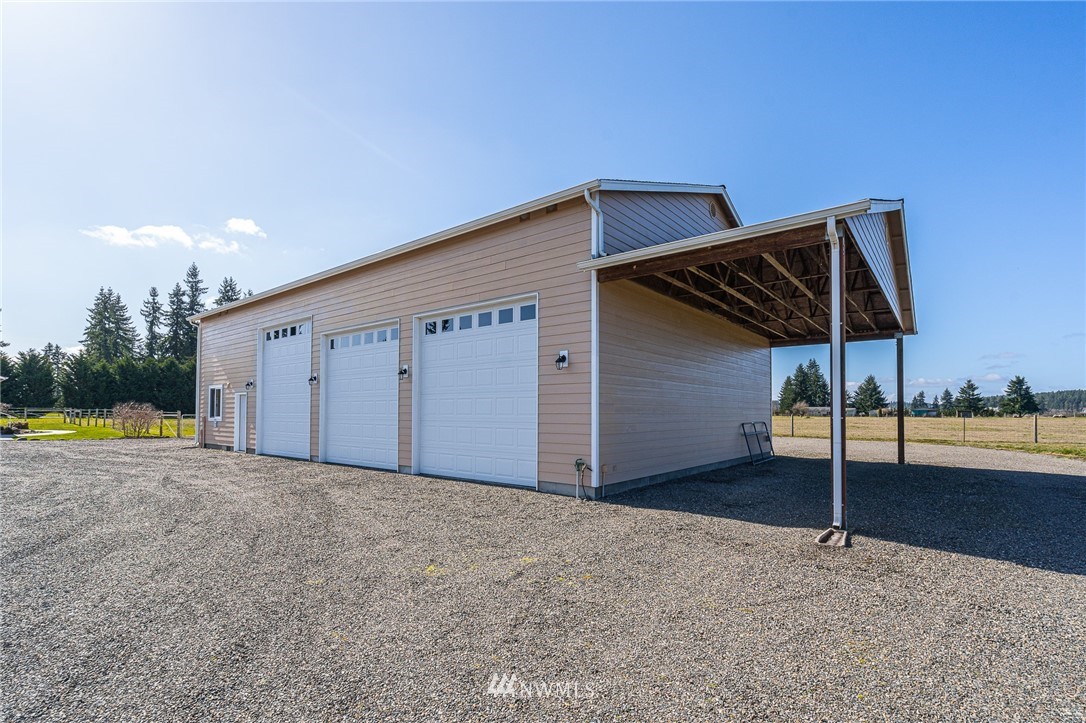 16847 Sheldon Lane Southwest Rochester, WA 98579 - Photo 12 of 40 a view of a house with backyard and a patio