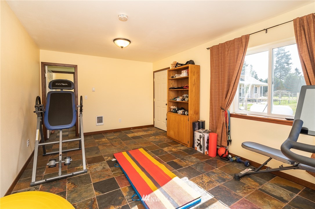 16847 Sheldon Lane Southwest Rochester, WA 98579 - Photo 19 of 40 a bedroom with a bed and glass windows