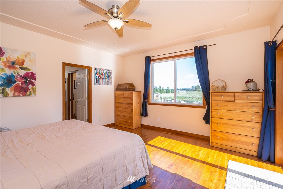 16847 Sheldon Lane Southwest Rochester, WA 98579 - Photo 28 of 40 a bedroom with a large bed and a window