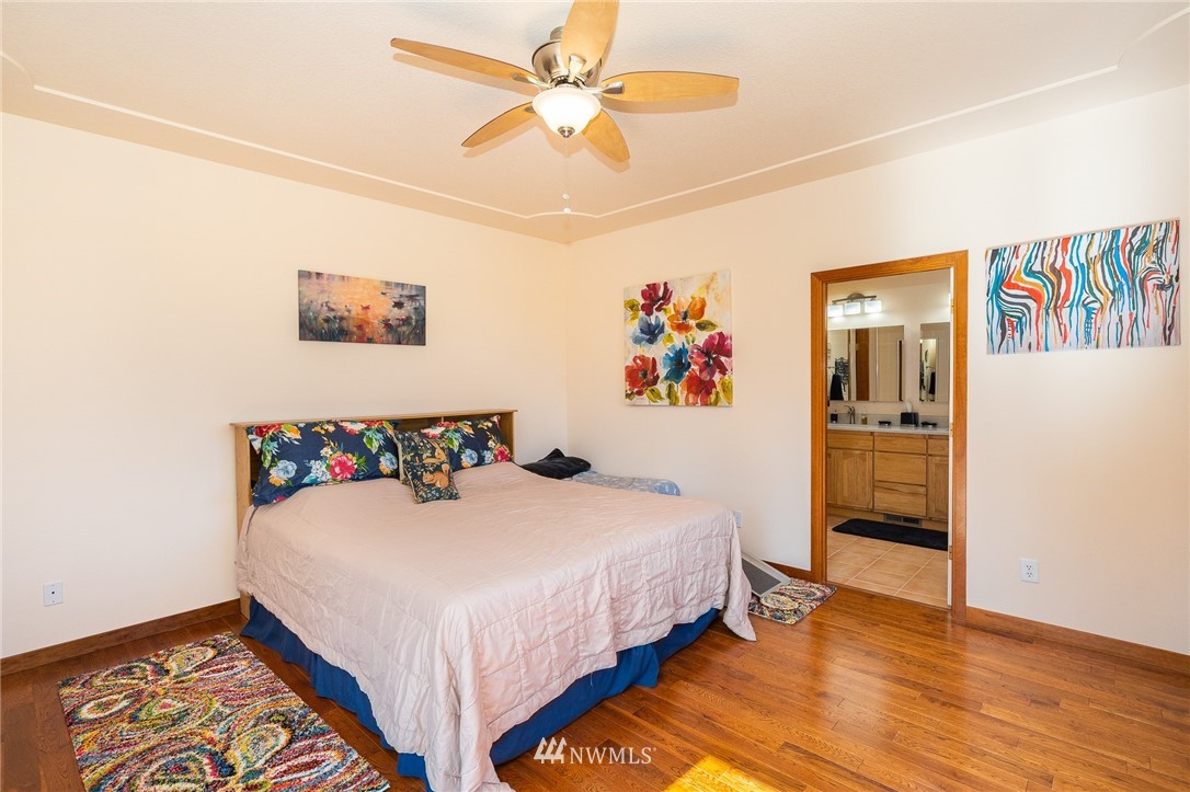 16847 Sheldon Lane Southwest Rochester, WA 98579 - Photo 29 of 40 a bedroom with a bed and a chandelier