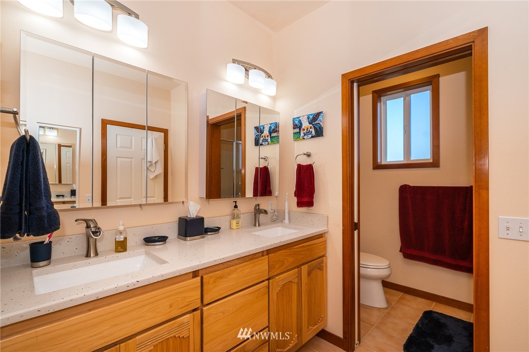 16847 Sheldon Lane Southwest Rochester, WA 98579 - Photo 31 of 40 a bathroom with double vanity sink and a mirror