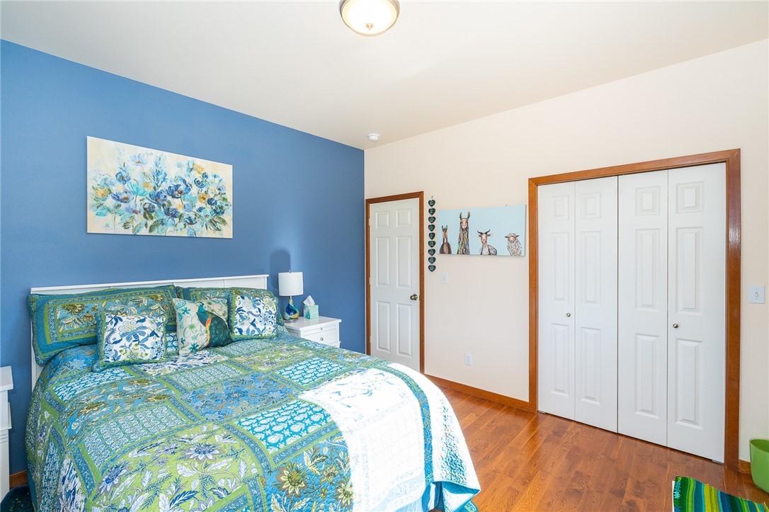 16847 Sheldon Lane Southwest Rochester, WA 98579 - Photo 33 of 40 a bedroom with a large bed and a chandelier