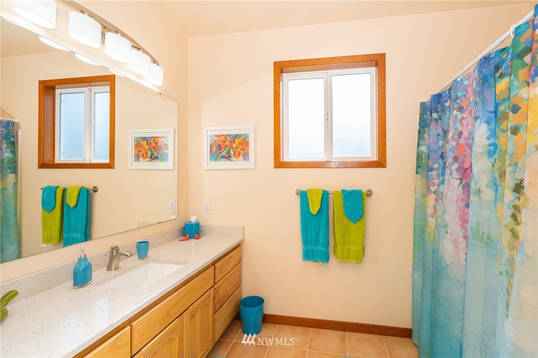 16847 Sheldon Lane Southwest Rochester, WA 98579 - Photo 34 of 40 a bathroom with a sink and a mirror