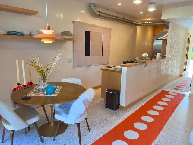 a kitchen with stainless steel appliances kitchen island granite countertop a table and chairs