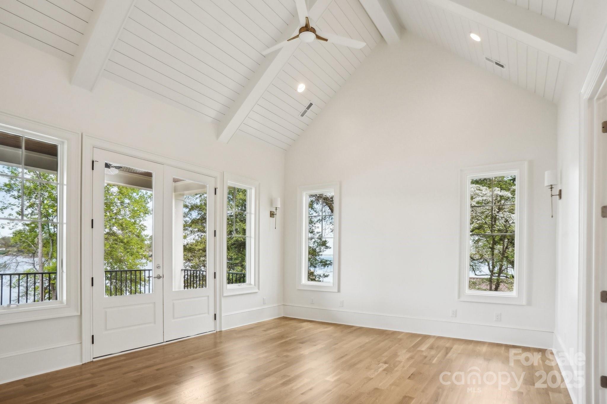 8813 Graham Road Denver, NC 28037 - Photo 16 of 35 a view of an empty room with a window and wooden floor