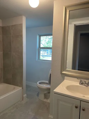 a bathroom with a sink a toilet and a bathtub