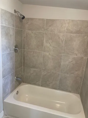 a white bath tub and a shower