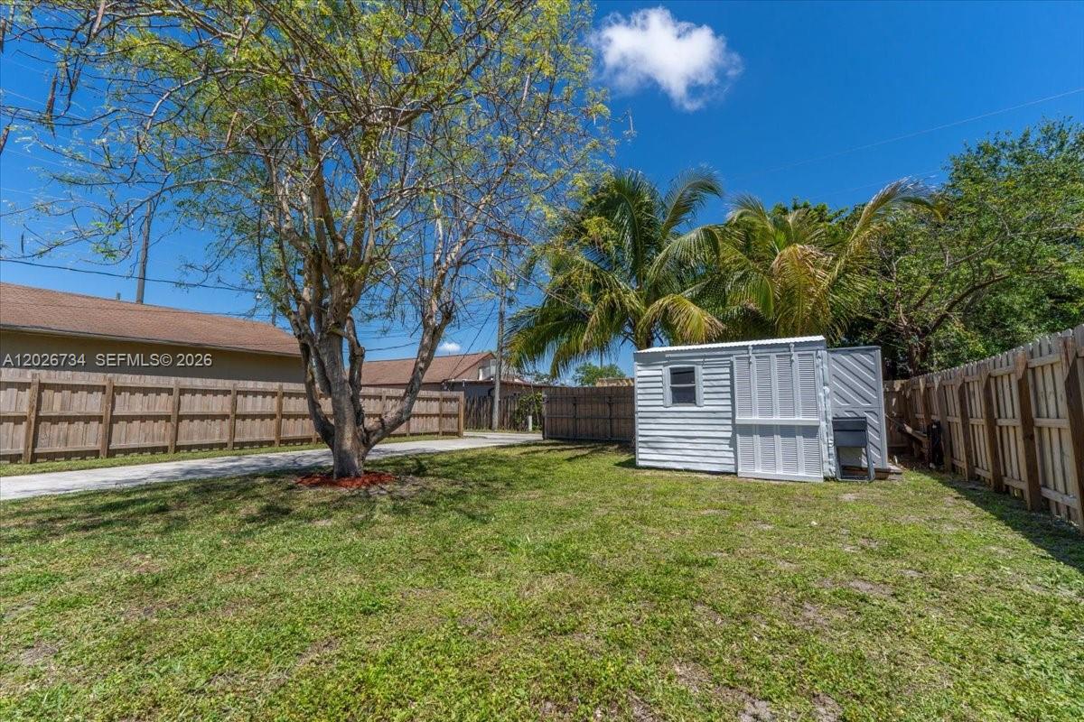 266 Southwest 6th Street Dania Beach, FL 33004 - Photo 30 of 37 a view of a backyard with a small cabin and a chair