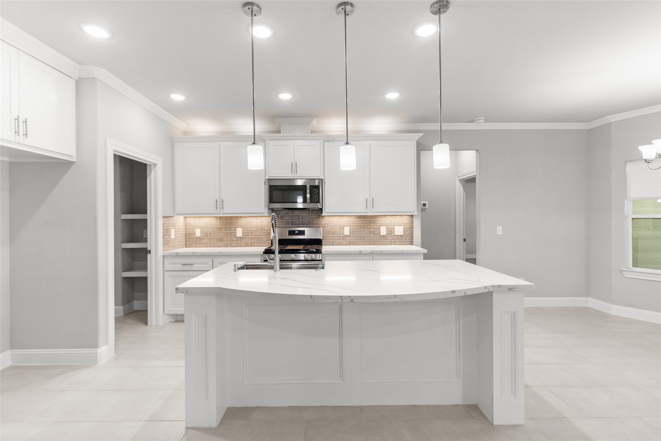 116 Augusta Drive Huntsville, TX 77340 - Photo 17 of 30 a large kitchen with kitchen island a sink stainless steel appliances and window