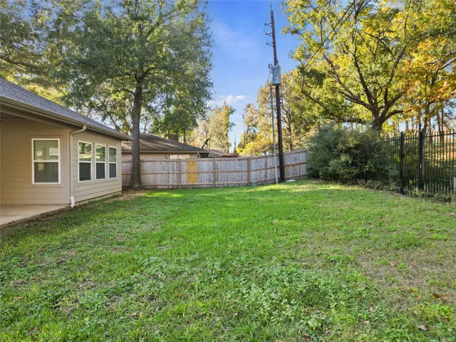 a view of a backyard with a large tree