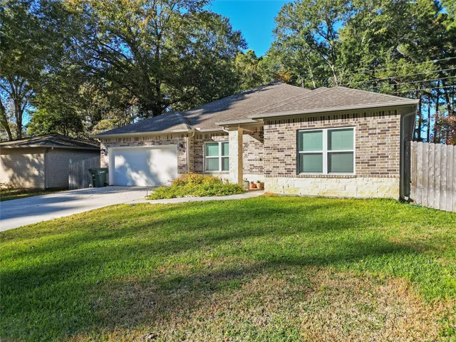 a front view of a house with a yard and porch
