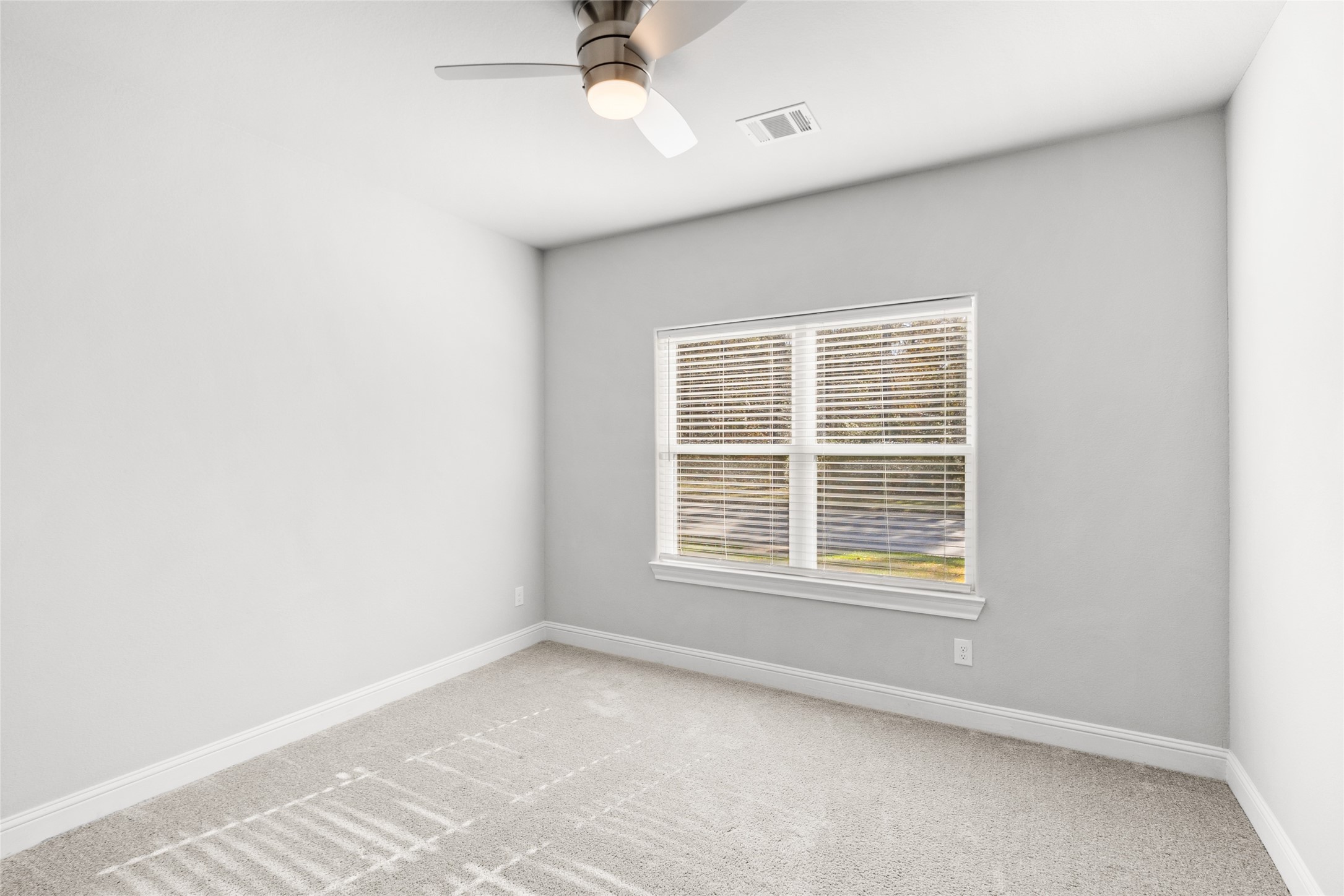 116 Augusta Drive Huntsville, TX 77340 - Photo 7 of 30 an empty room with a window and a fan