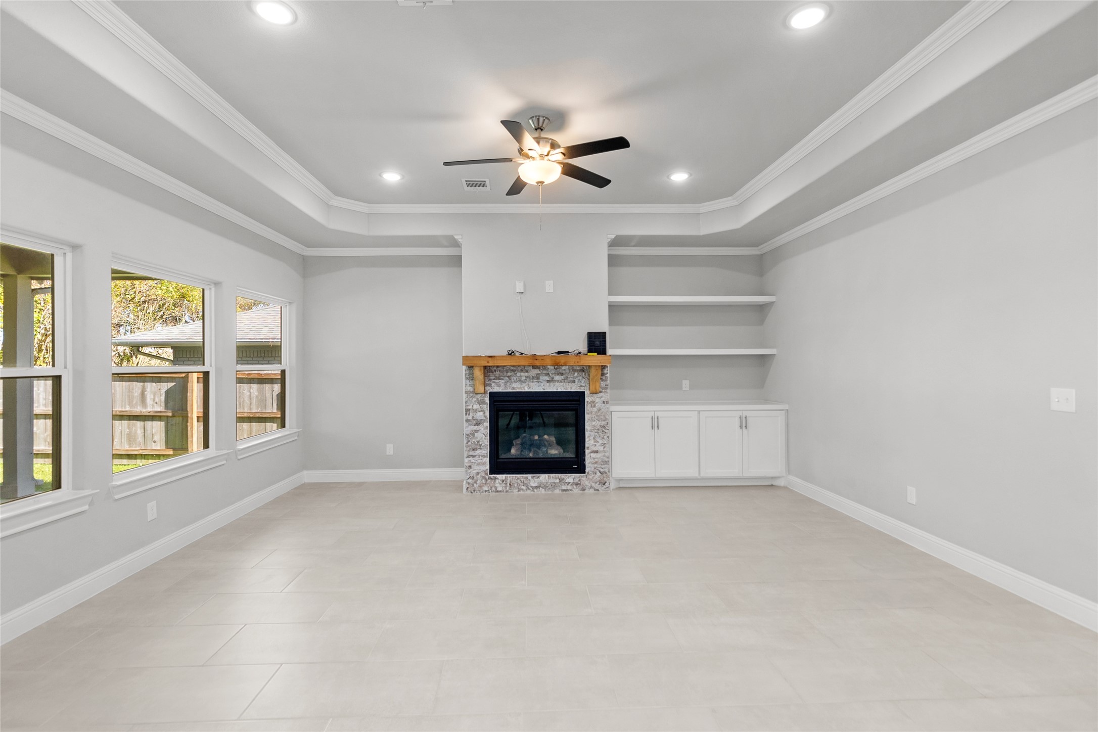 116 Augusta Drive Huntsville, TX 77340 - Photo 10 of 30 a view of an empty room with a fireplace and a window