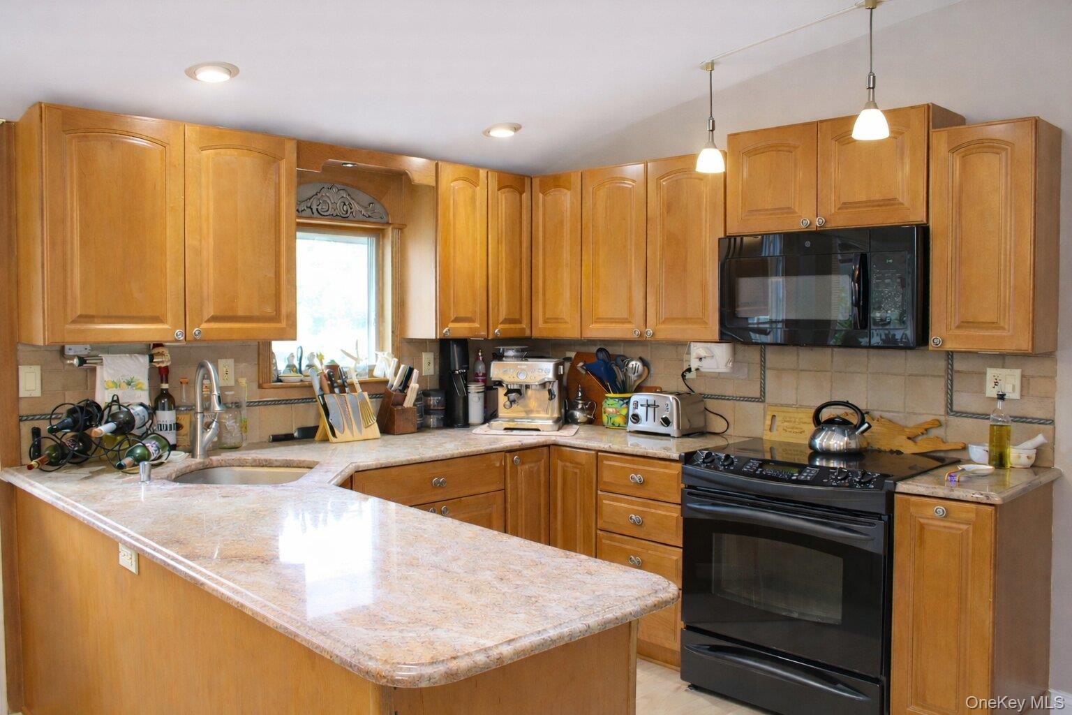 42 Shinbone Lane Commack, NY 11725 - Photo 7 of 23 a kitchen with stainless steel appliances granite countertop a sink a stove and a microwave