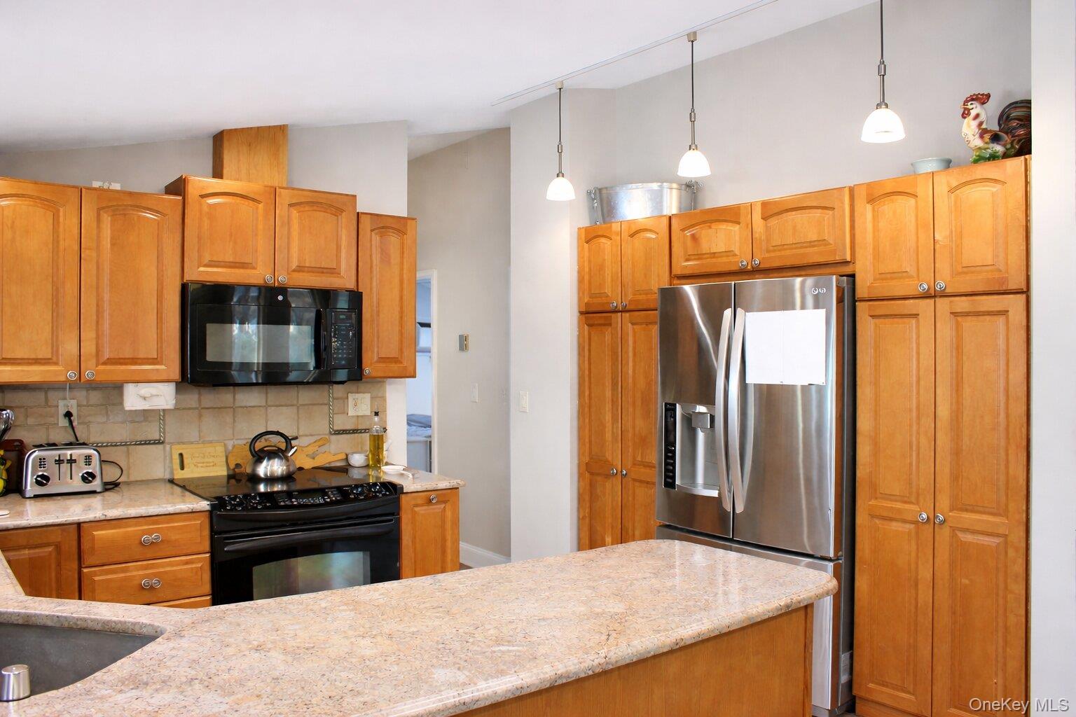 42 Shinbone Lane Commack, NY 11725 - Photo 8 of 23 a kitchen with stainless steel appliances granite countertop a refrigerator and a stove top oven