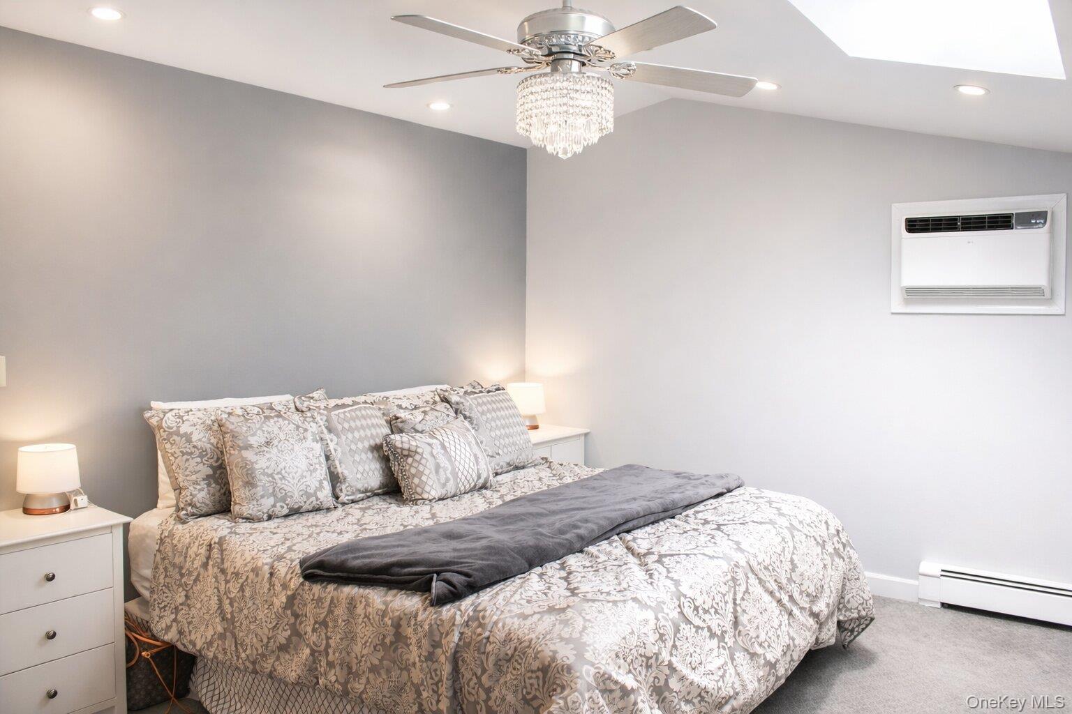 42 Shinbone Lane Commack, NY 11725 - Photo 10 of 23 a bedroom with a bed and a chandelier