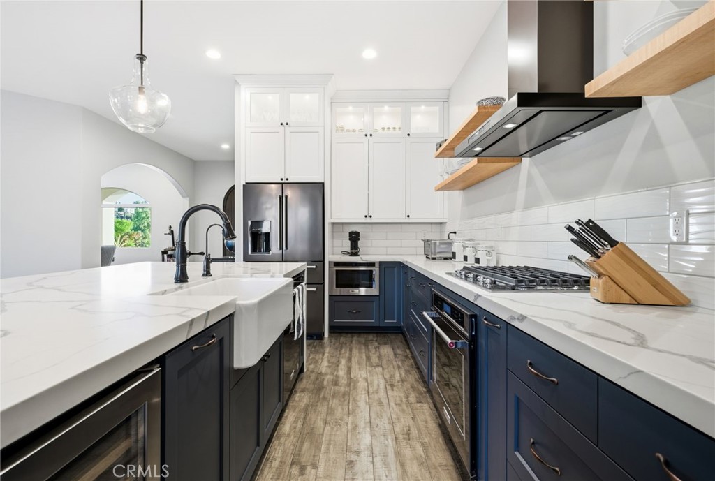 42339 Casa Verde Temecula, CA 92592 - Photo 12 of 59 a kitchen with kitchen island granite countertop a sink a counter space stainless steel appliances and cabinets