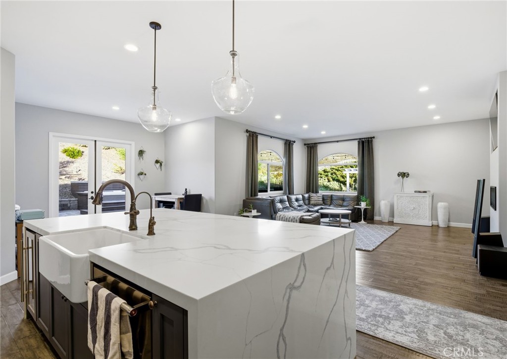 42339 Casa Verde Temecula, CA 92592 - Photo 13 of 59 a large kitchen with lots of counter space a sink appliances and living room view