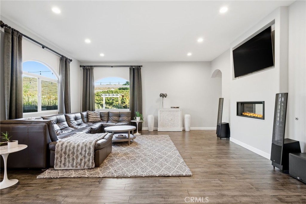 42339 Casa Verde Temecula, CA 92592 - Photo 17 of 59 a living room with fireplace furniture and a flat screen tv