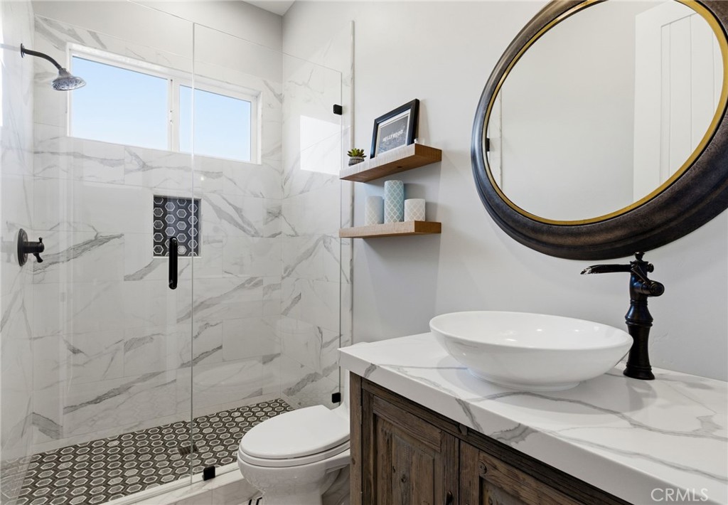 42339 Casa Verde Temecula, CA 92592 - Photo 21 of 59 a bathroom with a toilet a sink and mirror