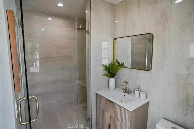 a bathroom with a sink a mirror and a shower