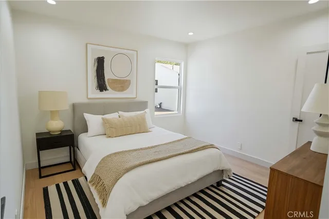 a bedroom with a bed and a lamp on table