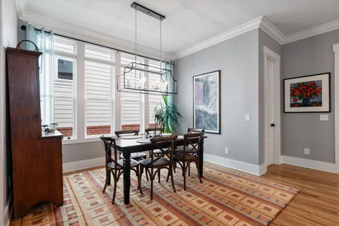 a view of a dining room with furniture window and wooden floor