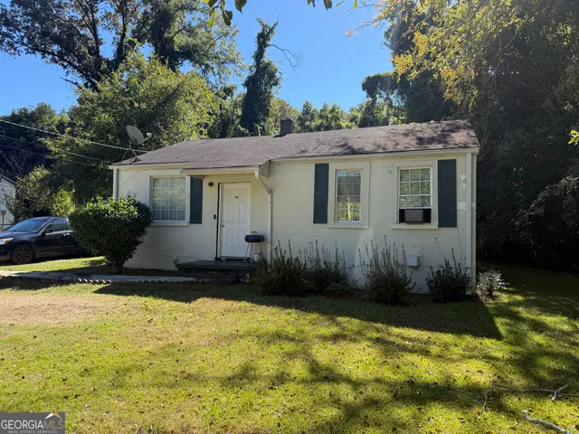a view of a house with pool and sitting area