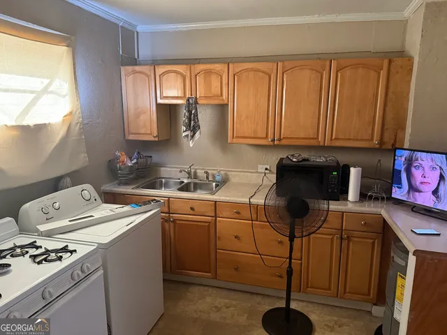 a kitchen with a sink cabinets and window