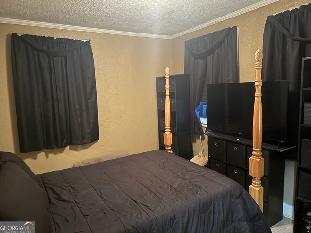 a bedroom with a bed window and bathroom