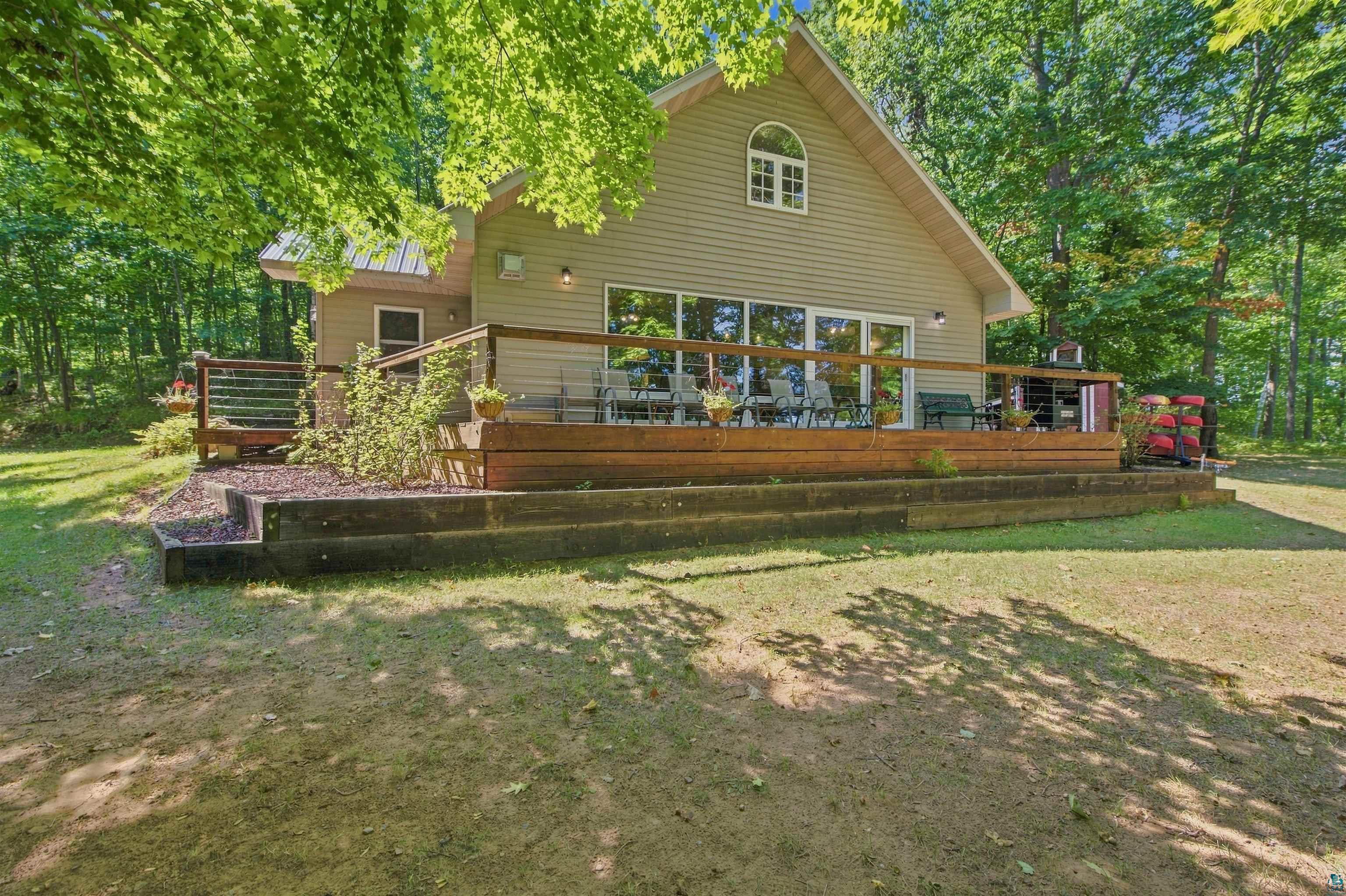 69085 East Long Lake Road Iron River, WI 54847 - Photo 2 of 33 Siding exterior with a metal roof and an arched window