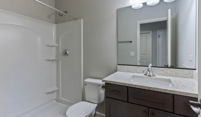 a bathroom with a sink toilet and shower