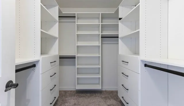 a view of walk in closet with empty racks