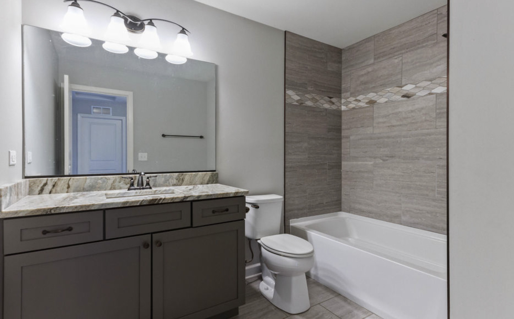 2205 Maple Hill Downers Grove, IL 60516 - Photo 10 of 18 a bathroom with a granite countertop sink a toilet and bathtub