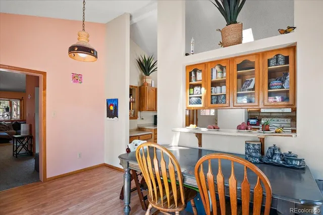 a view of a dining room with furniture and wooden floor