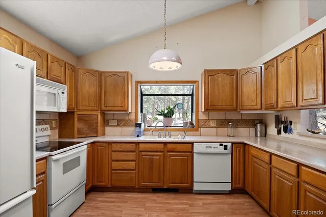 a kitchen with stainless steel appliances a sink stove and cabinets