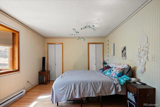 a bed sitting in a bedroom next to a window