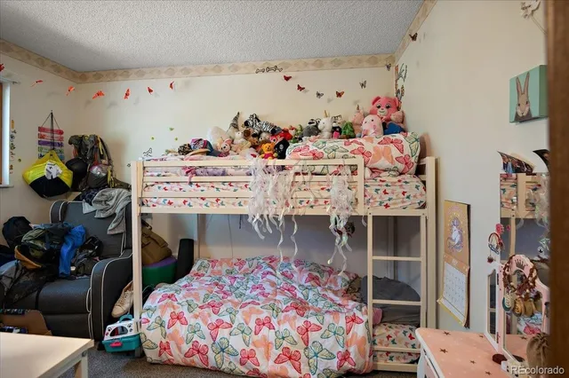 a bedroom with furniture and a baby bed