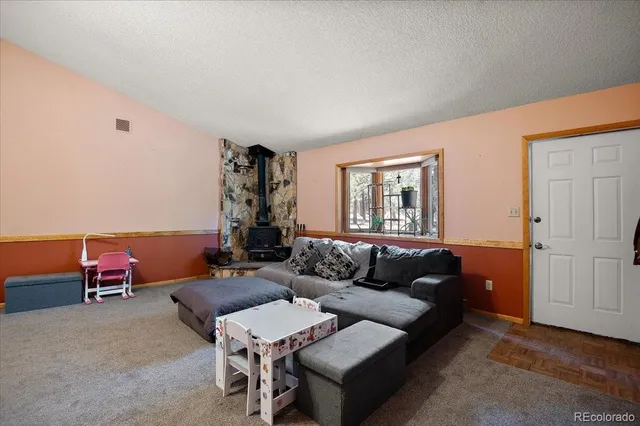 a living room with furniture a table and a window