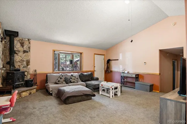 a bedroom with furniture and a flat screen tv